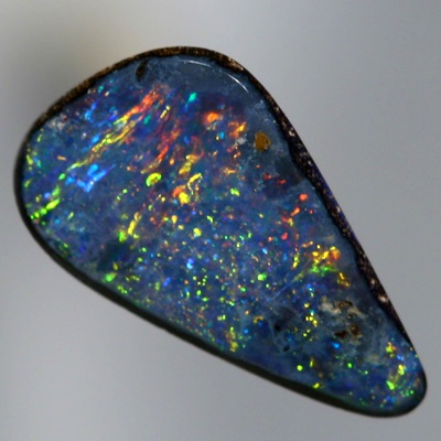 SOLID BOULDER OPAL Bright sparkles of red and gold over blue